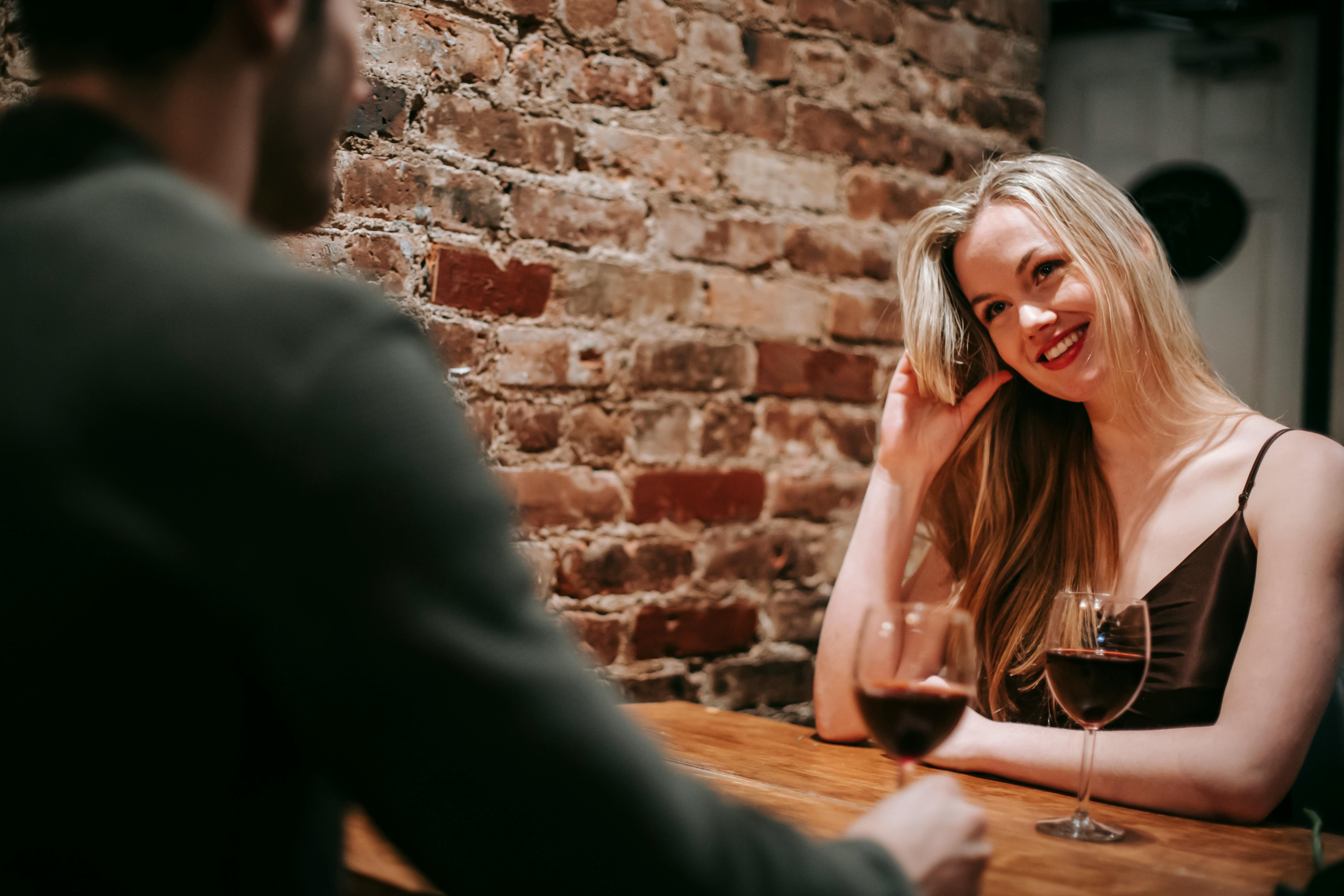 A woman smiling while out with someone | Source: Pexels