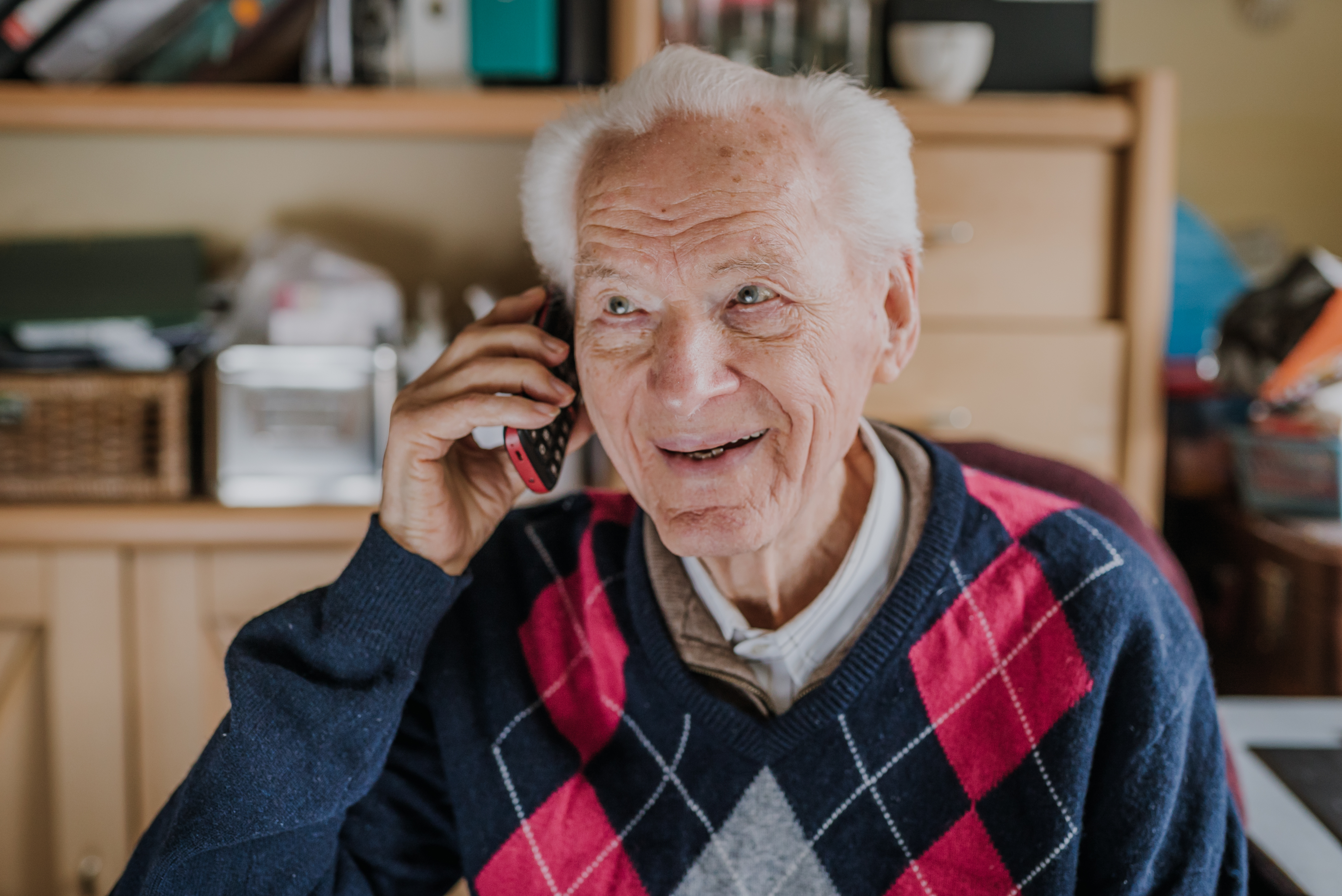 A man smiling while talking on the phone | Source: Getty Images