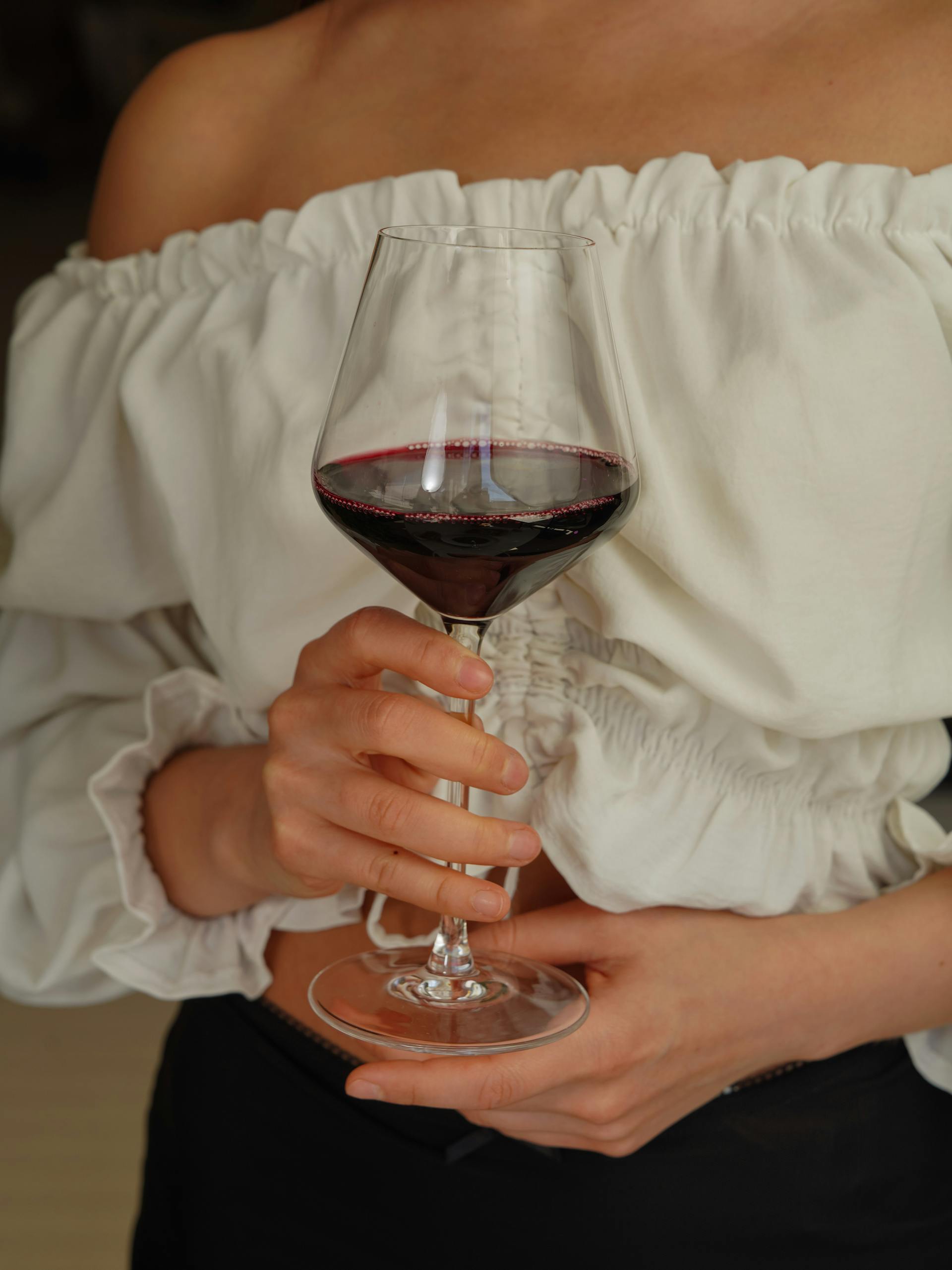 A woman holding a glass of wine | Source: Pexels