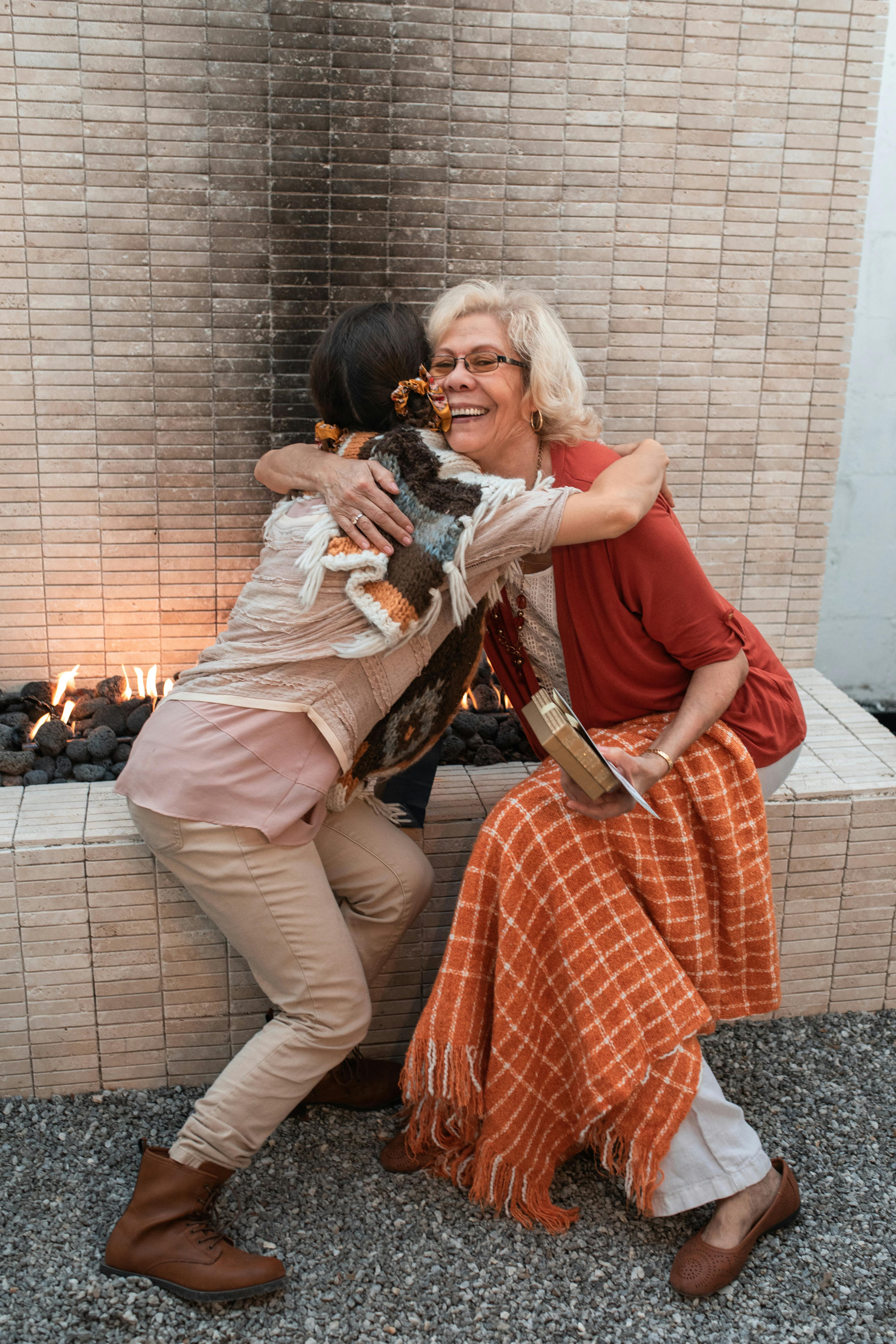 A grandmother hugging her granddaughter | Source: Pexels