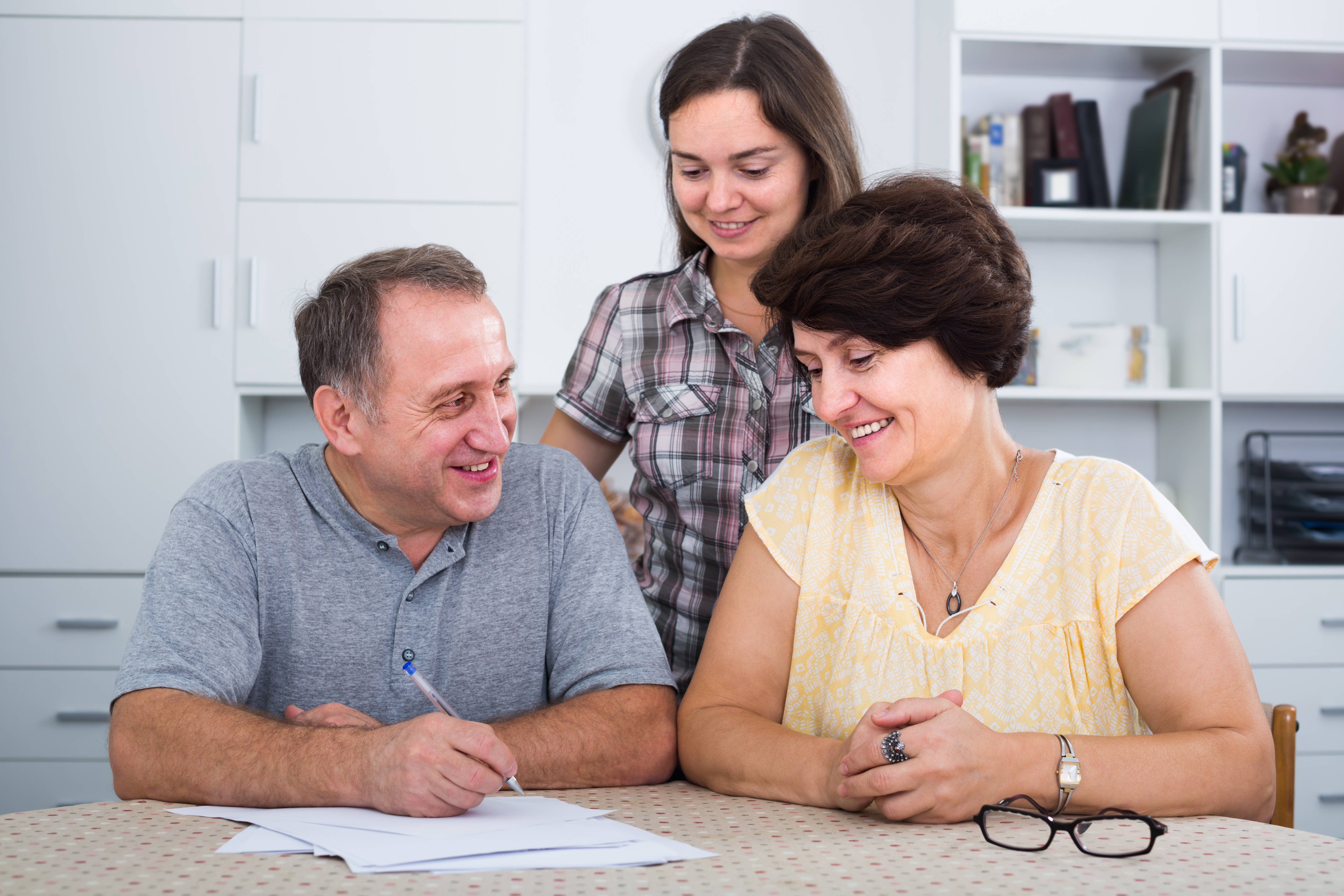 Parents giving cash gift to daughter | Source: Getty Images