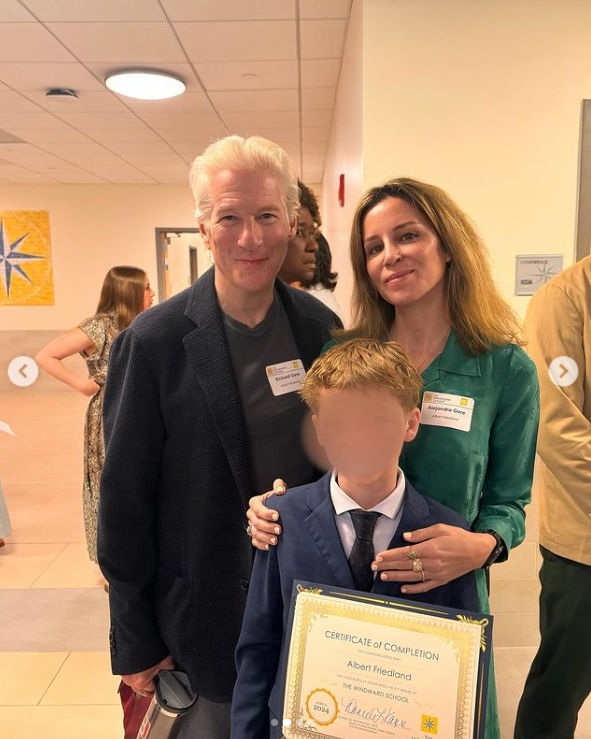 Richard Gere and Alejandra Silva pose with Albert holding a school certificate, June 2024. | Source: Instagram/alejandragere