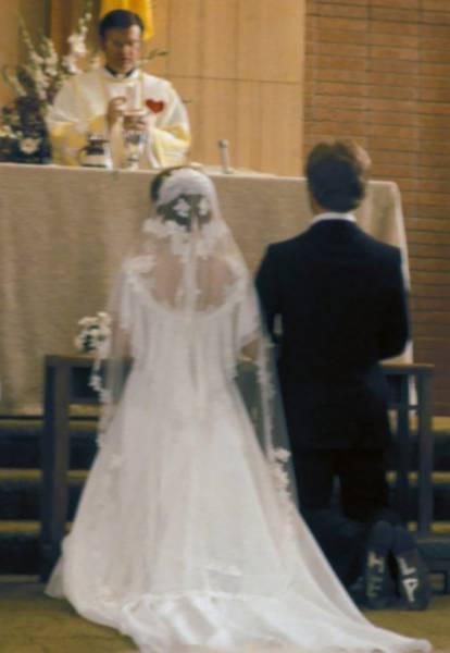  That groom is carrying a secret message... on his feet